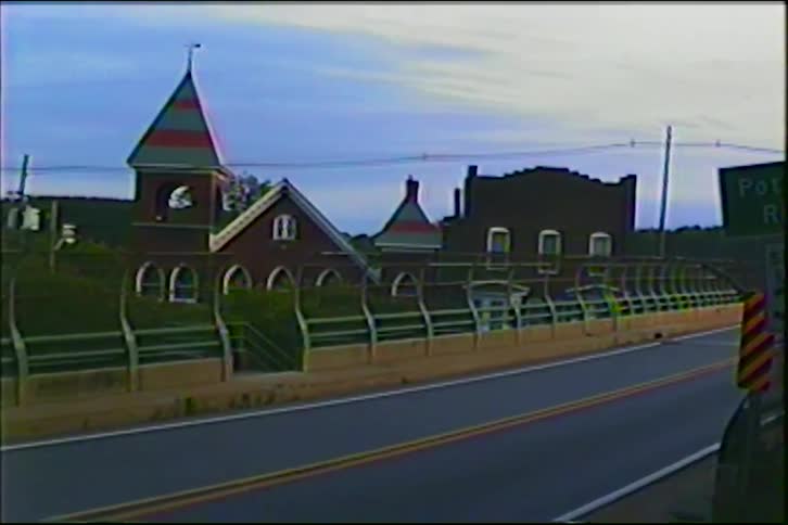 Vintage VHS footage zooms out from a 'Potomac River' sign to reveal a bridge and a historic town