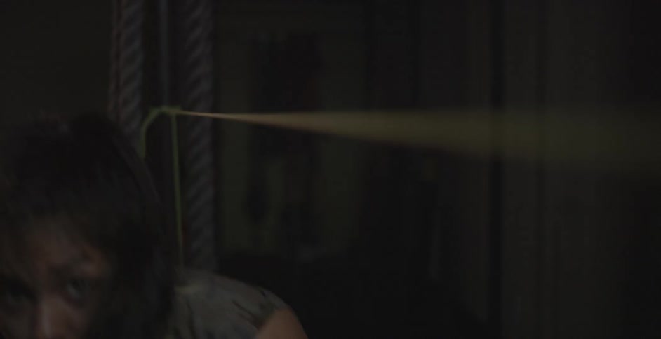 A woman trains by bobbing and weaving under a rope and punching