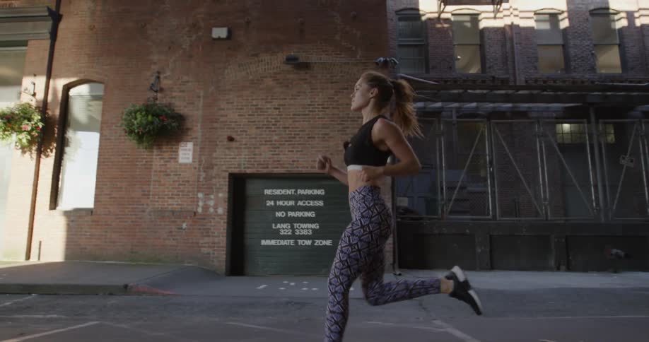 A woman jogs through the city