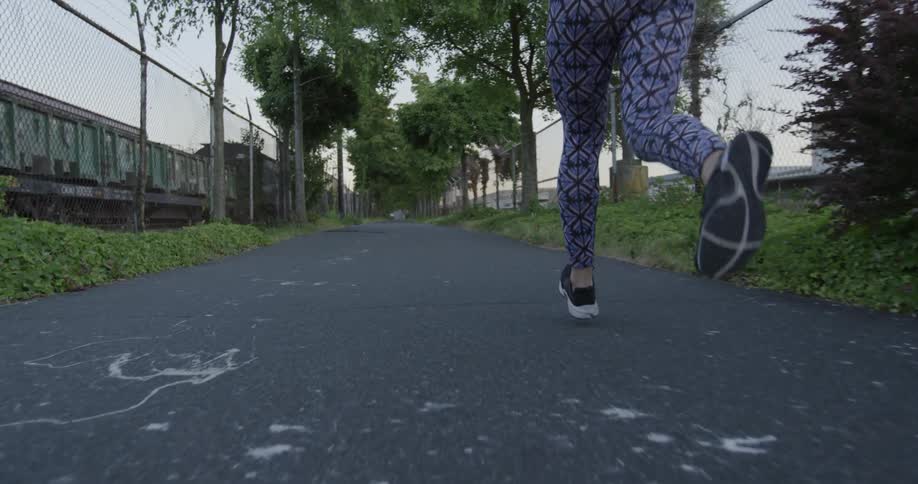 A woman jogs down the street