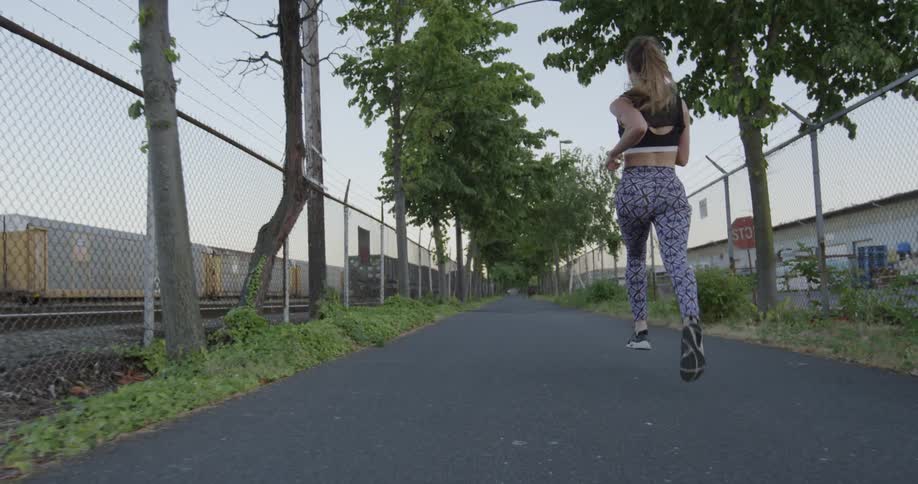 A woman jogs down the street