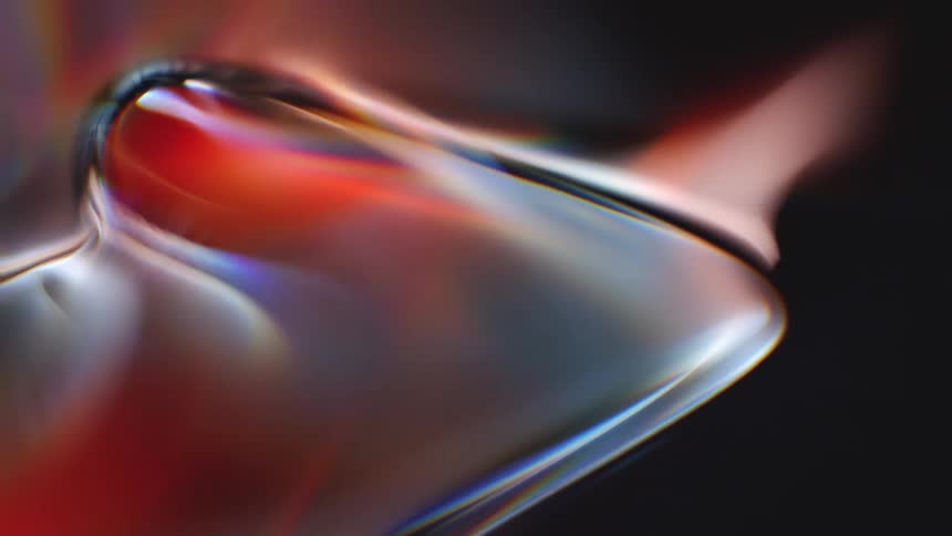 A smooth and futuristic abstract animation of liquid glass shapes slowly morphing and refracting colorful light