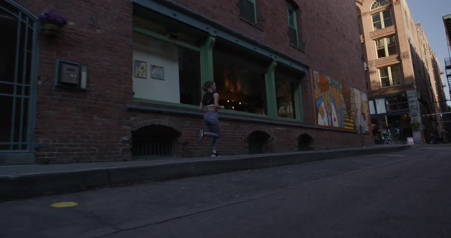 Woman jogging in a city on the sidewalk
