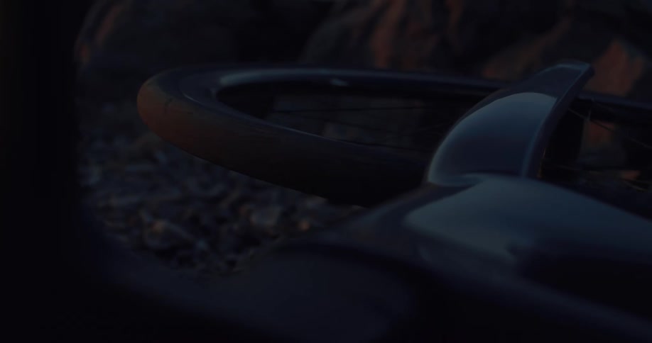 Close-up on a fallen bicycle on a gravel trail in the dim light of dusk