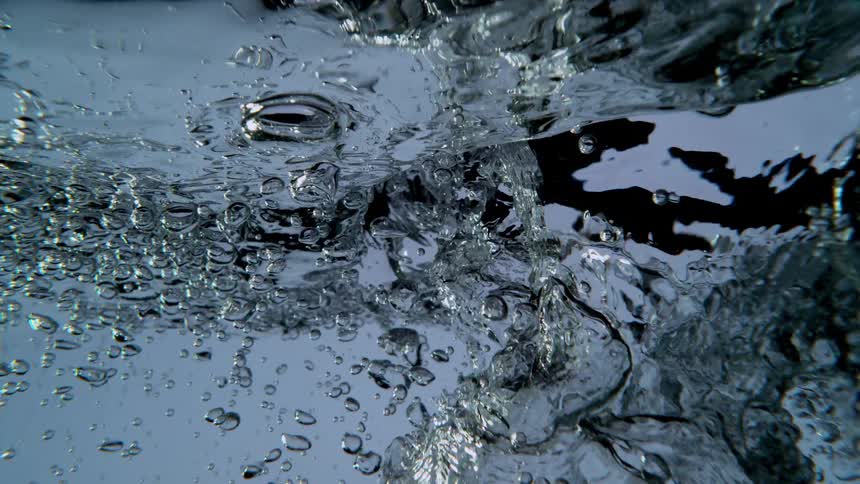 A mesmerizing underwater view of clear water bubbling and churning in slow motion