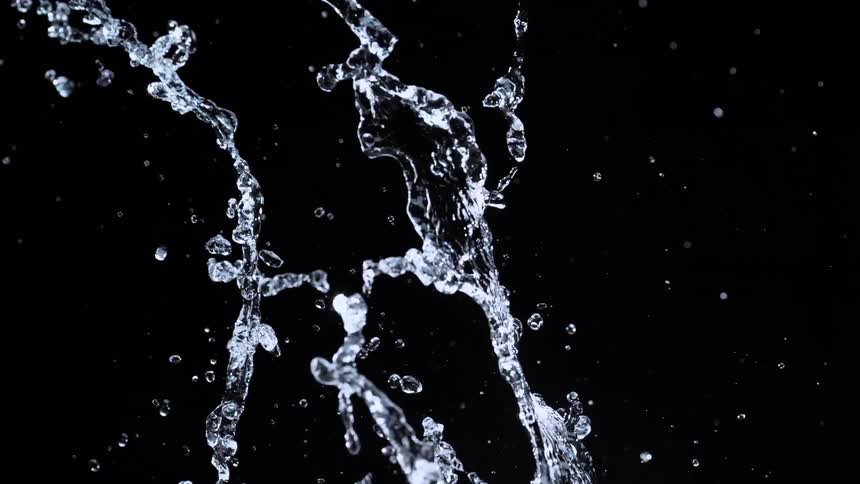A dynamic splash of clear water erupts upwards in slow motion against a black background