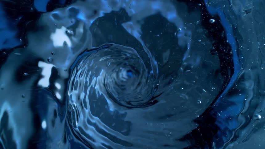 Mesmerizing top-down slow-motion shot of a deep blue water vortex spinning and creating a powerful whirlpool