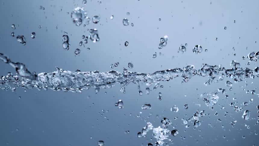 Crystal clear water stream splashes horizontally in mesmerizing super slow motion
