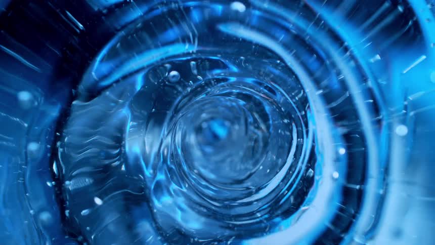 A hypnotic macro view of a swirling blue liquid forming a powerful vortex tunnel
