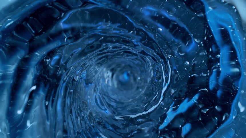 A mesmerizing top-down slow-motion view into a swirling blue water vortex creating a powerful liquid tunnel