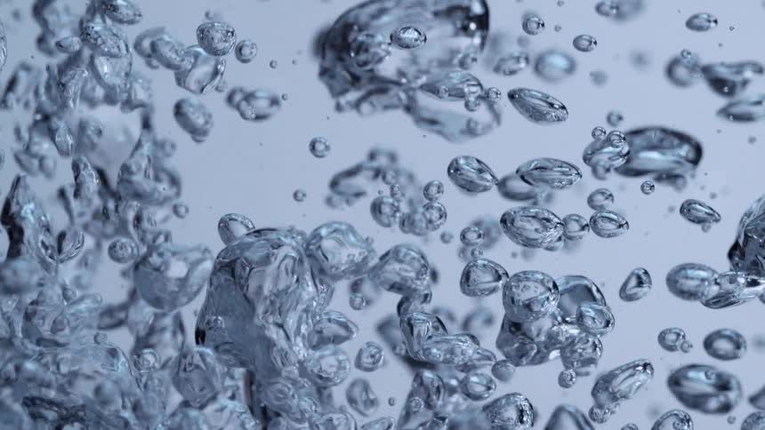 Mesmerizing super slow motion close-up of air bubbles rising and churning in pristine water