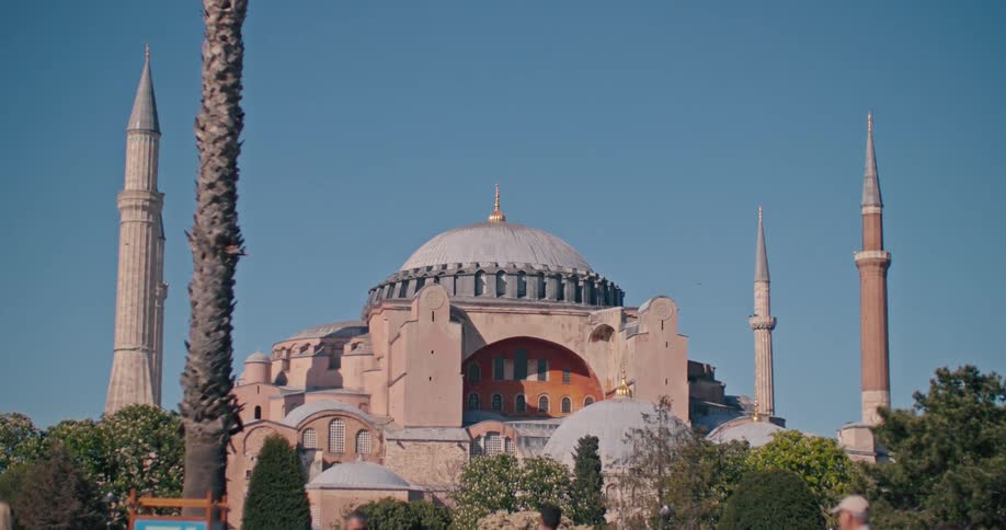 The magnificent Hagia Sophia Grand Mosque in Istanbul stands tall against a clear blue sky on a sunny day