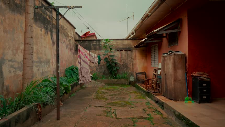 A quiet, weathered residential courtyard with clothes drying on a line on an overcast day