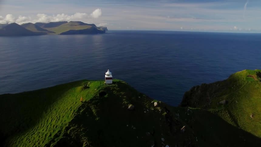 A building sits atop an island cliff
