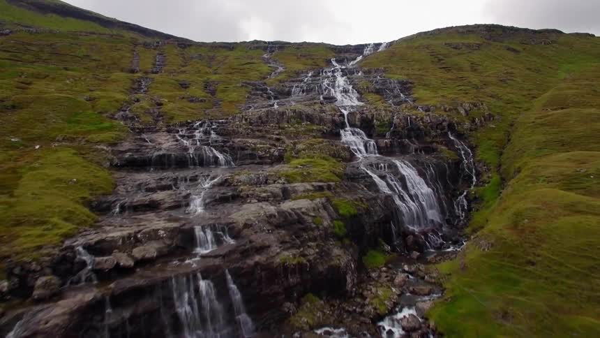 Water flows down rocks on the cliffside
