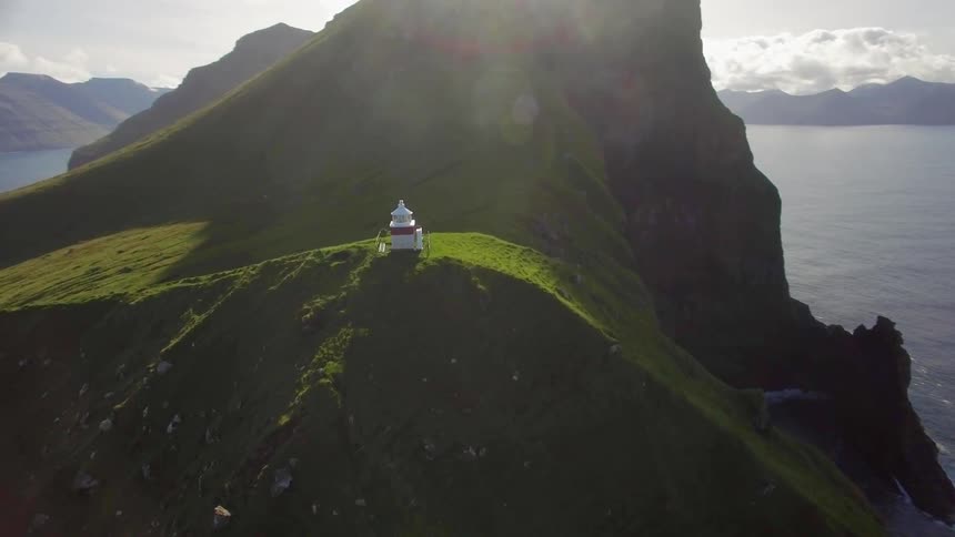 A building sits atop a hilly island