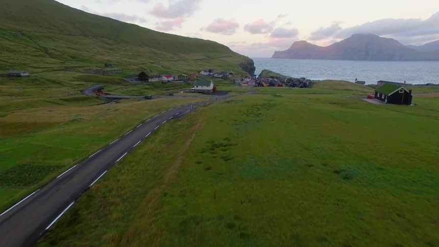 A person is walking down a long small road