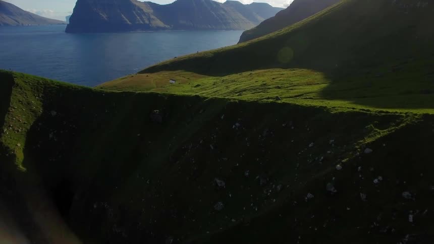 A tower sits on the green mountain