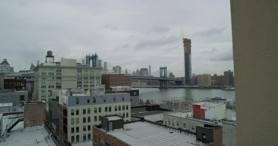 A city near a lake on a cloudy day