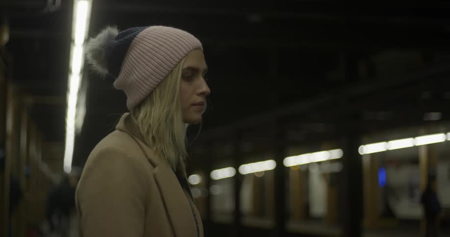 A woman is waiting for a train