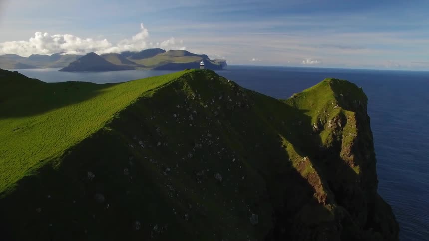 Moss grows atop a hill next to the ocean