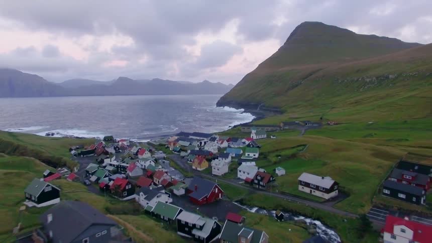 Small village next to water on a cloudy day