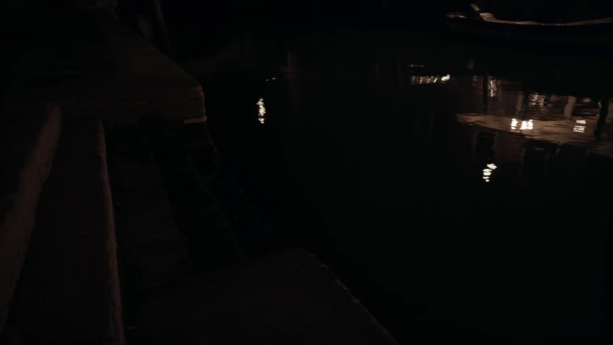 Lights are reflected in the water at night