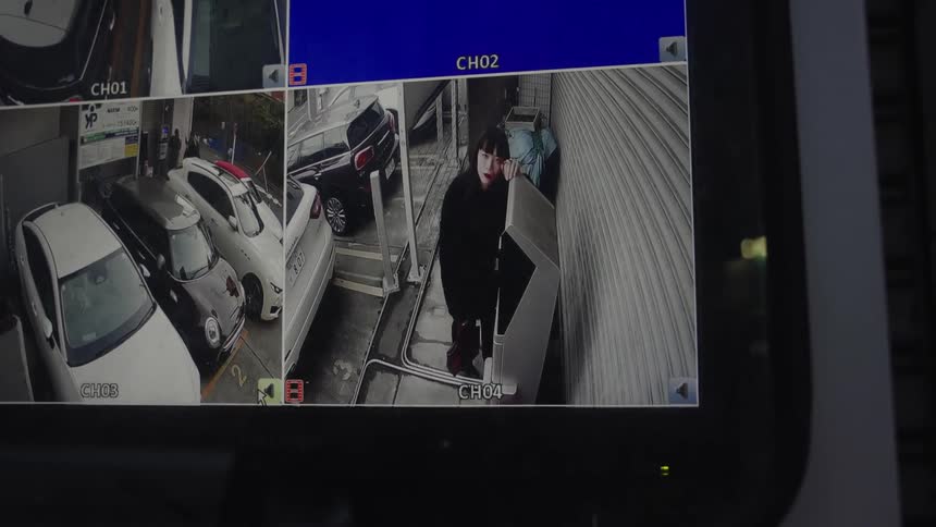 CCTV security camera footage shows a distressed woman hiding in an alley next to a car park