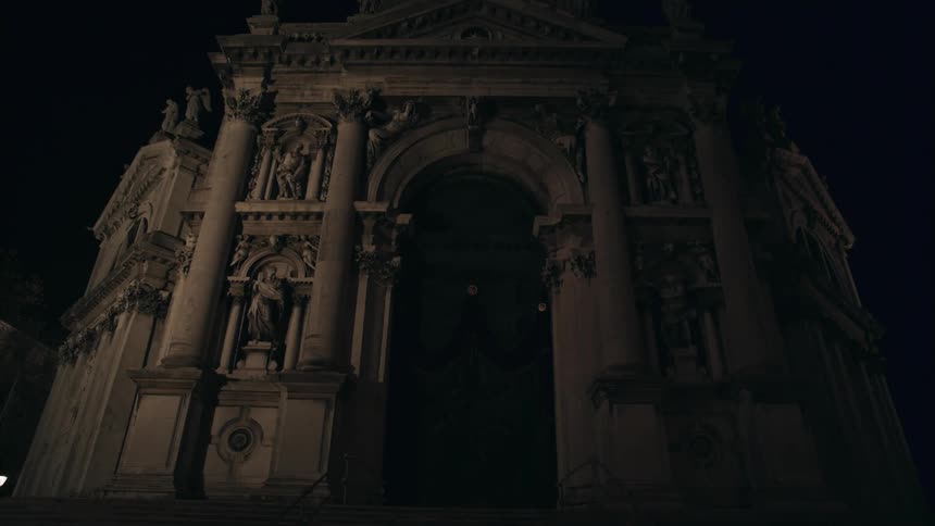 A building arch is shown at night