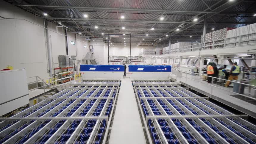 An aerial tour of a massive, modern, and automated food processing plant with intricate conveyor systems