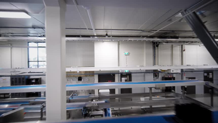 A sweeping tour through a modern, automated food processing and packaging facility, showcasing the complex network of conveyor belts and machinery