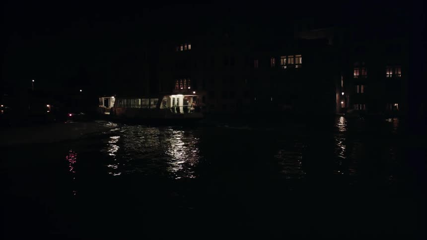 A large boat sails in the dark