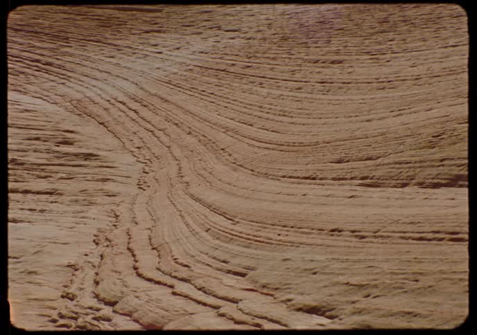 Vintage film slide captures a detailed, static shot of the wavy, layered striations in a sandstone rock formation