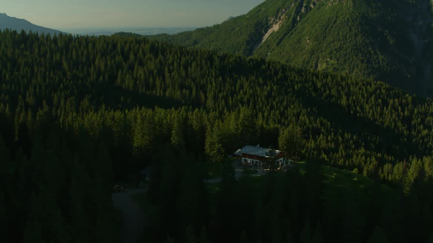 A building sits in the mountains surrounded by trees