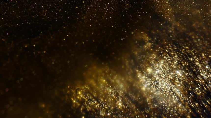 An elegant, abstract background featuring golden glitter particles shimmering and sparkling in slow motion