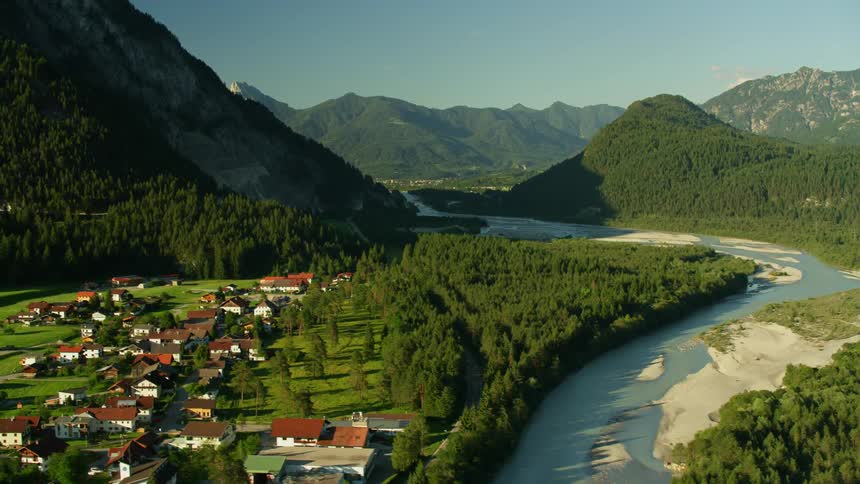 A river flows by a mountain town