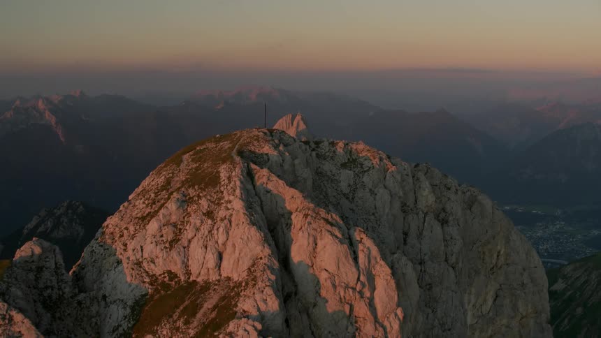 Cross on top of a mountain at sunrise