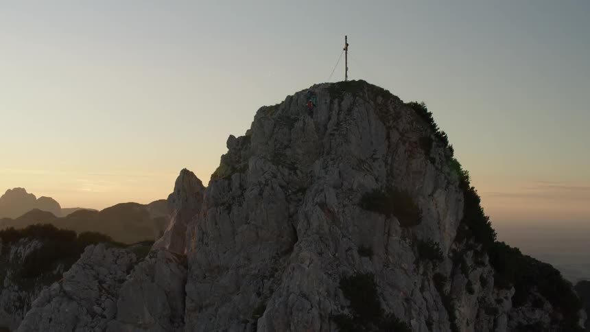 Large cross sitting high above on a mountaintop