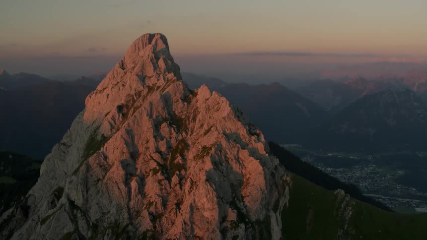 The tall mountain has a sharp top at dawn