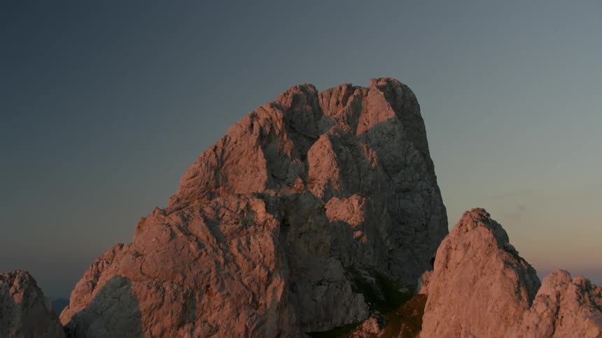 The top of the mountain is reflecting the dawn sun