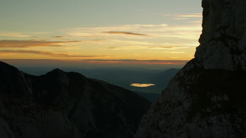 Rocky peaks look over the colorful sky at sunset