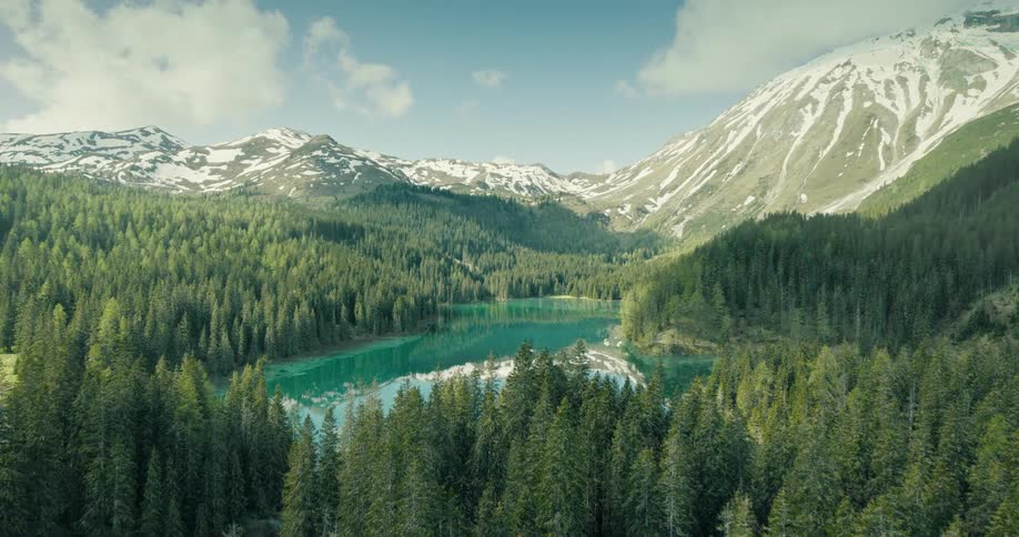 A breathtaking time-lapse shows a mountain landscape transforming from a snow-covered winter to a verdant spring