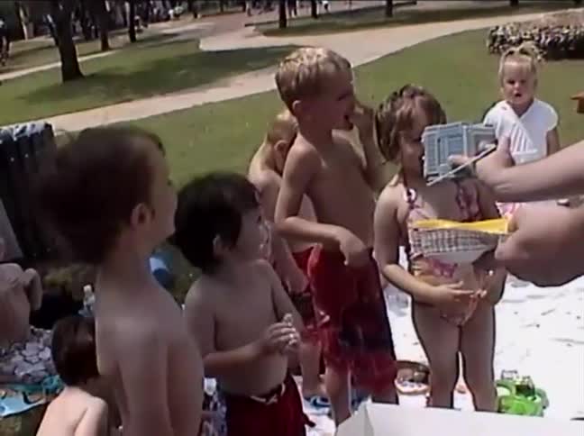 A hilarious home video shows a little boy licking the frosting off the spatula and getting it all over his face at his birthday party