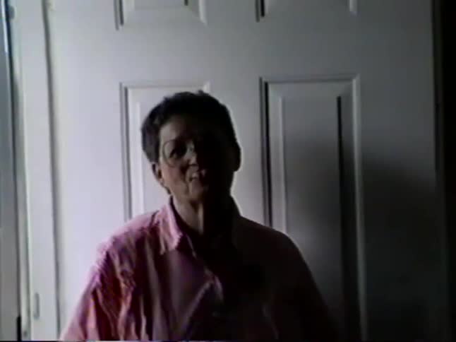 Vintage home movie footage shows a grandmother arriving at a home and making a silly face for the camera