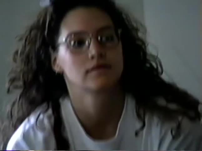 Vintage home video from the 1990s shows a family gathering in a living room, ending with a slow zoom into a young woman's face