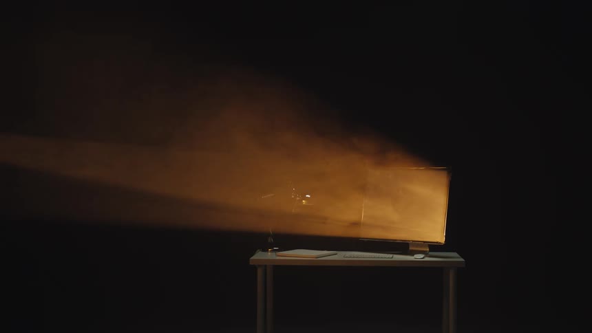 A vintage television set on a table emits a glowing beam of light through a dark and smoky room