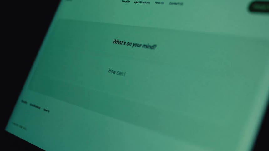 A person types the question 'How can I solve' into a minimalist user interface on a computer screen in a dark room
