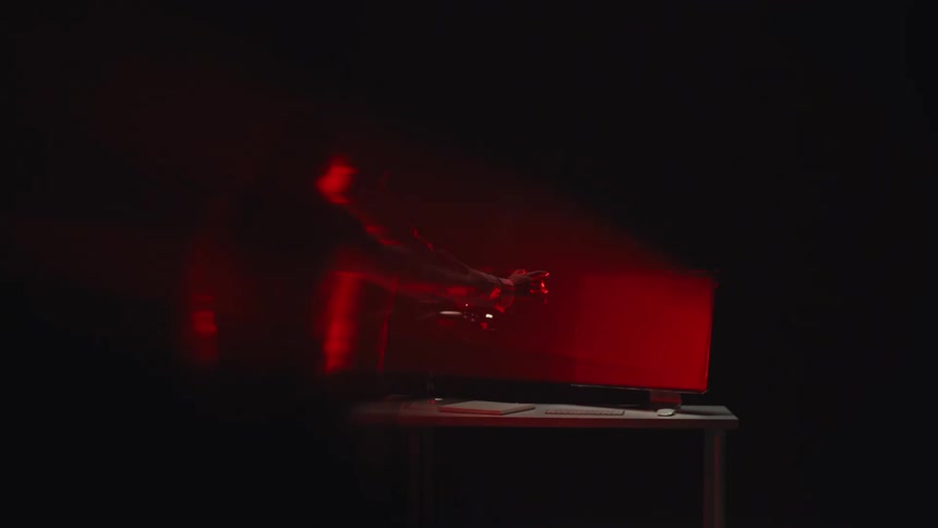 A sinister red light illuminates a man's horrifying transformation as his arm mutates in slow motion