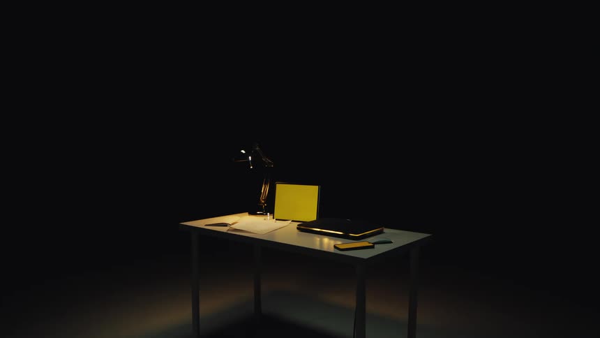 A mysterious work desk with a laptop and lamp is illuminated by a single spotlight in a dark room as a yellow sticky note appears