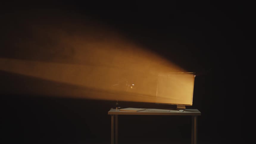 A vintage television casts a volumetric beam of orange light through a dark and hazy room